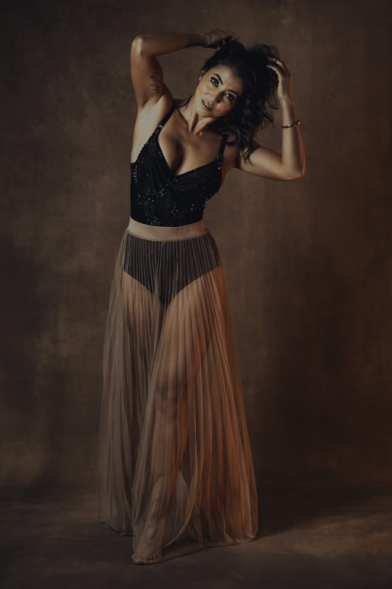 Laura in a warm, dark editorial portrait