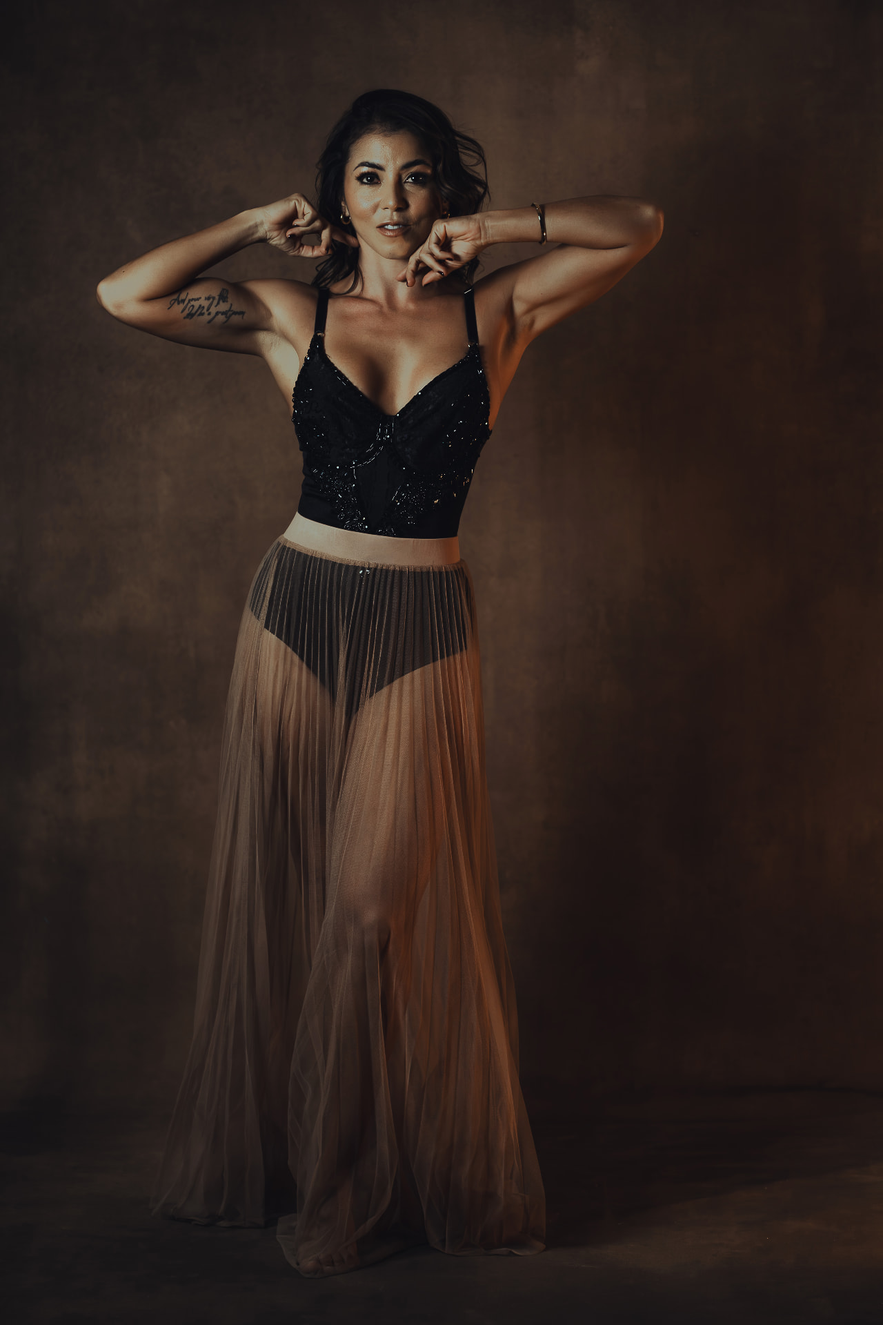 Laura in a warm, dark editorial portrait